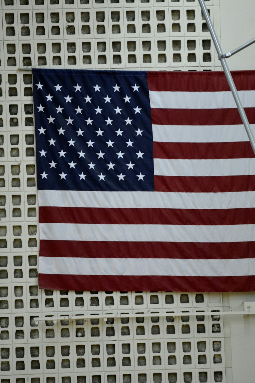 an american flag hanging on the side of a building