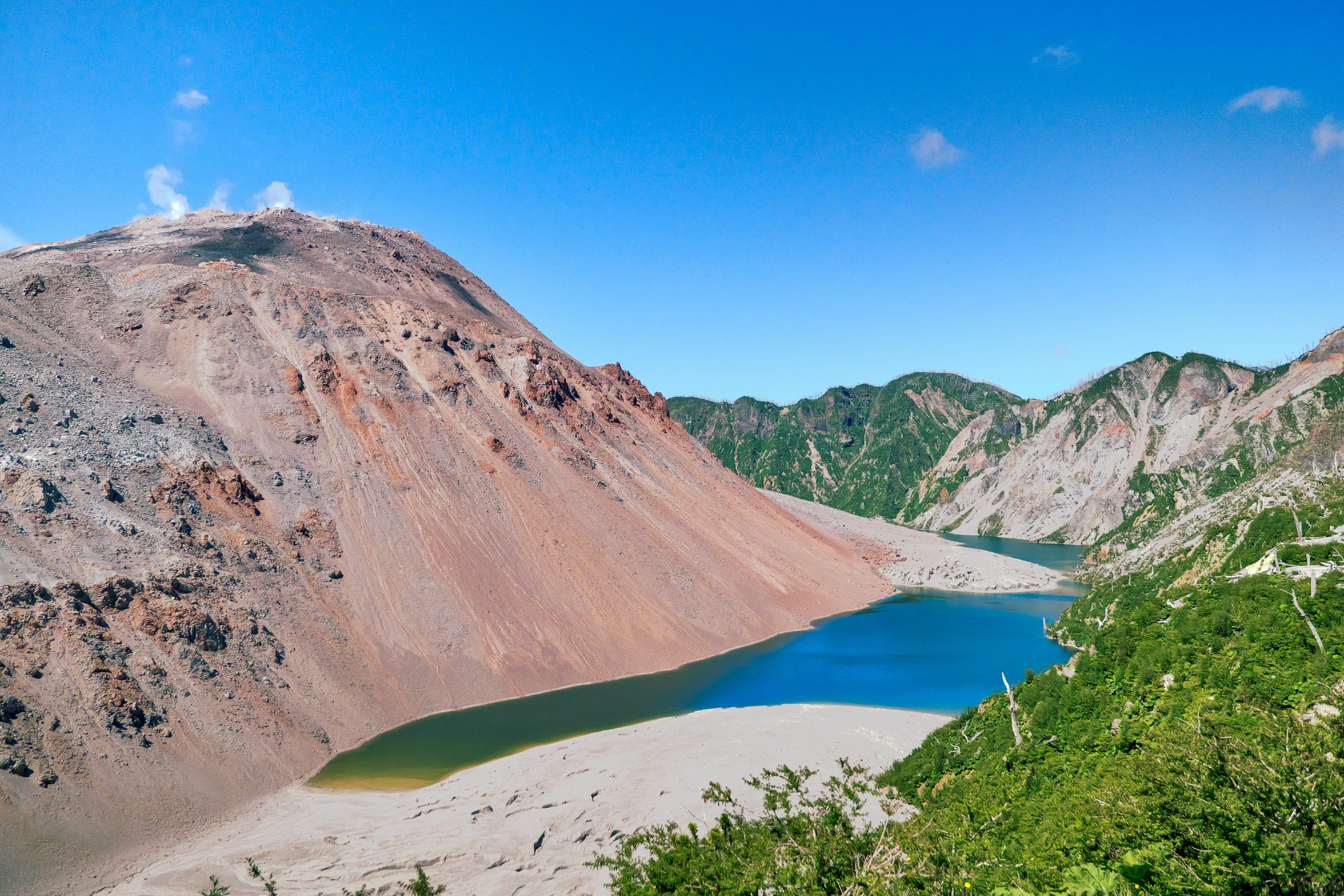 The slopes of the Chaitén volcano with a blue lagoon at its foot, Chilean Patagonia