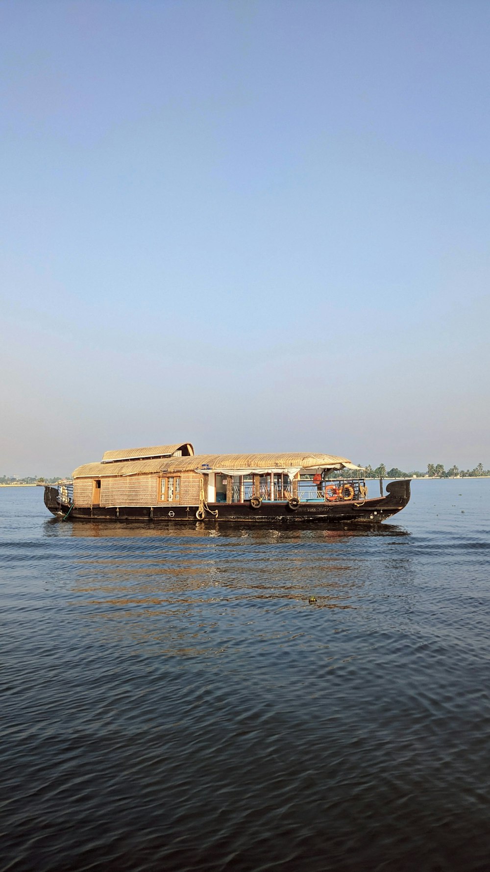 a long boat is floating on the water