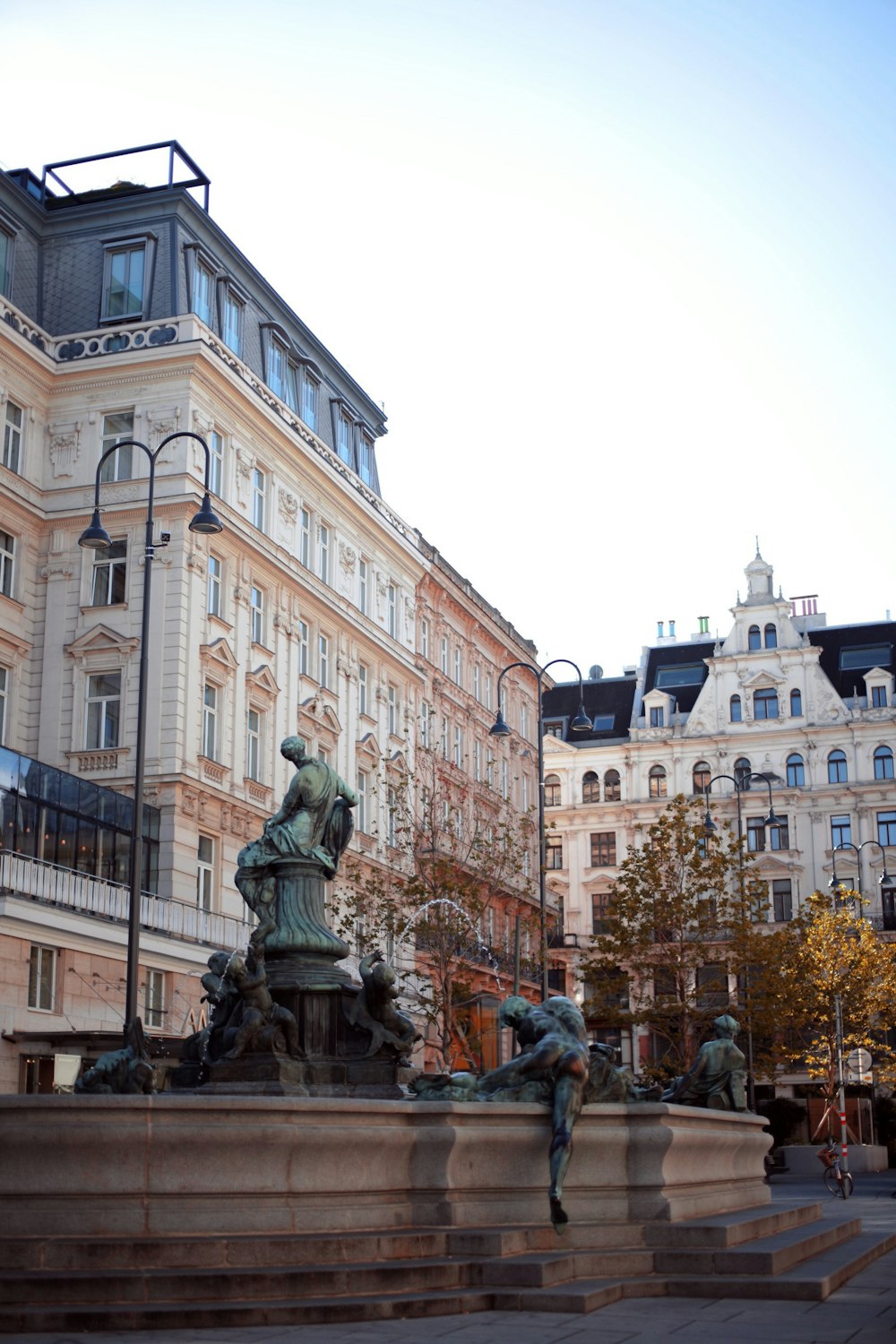 a statue of a man sitting on top of a fountain