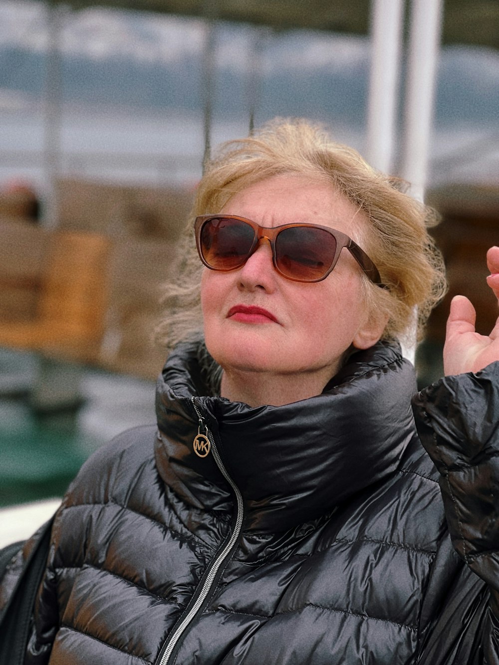 a woman wearing a black jacket and sunglasses