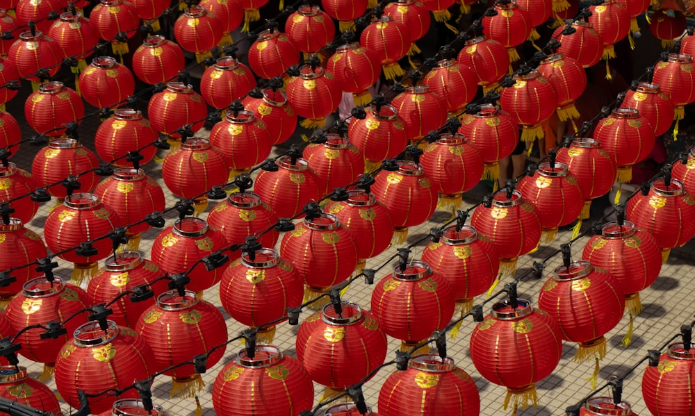 a large group of red lanterns are lined up