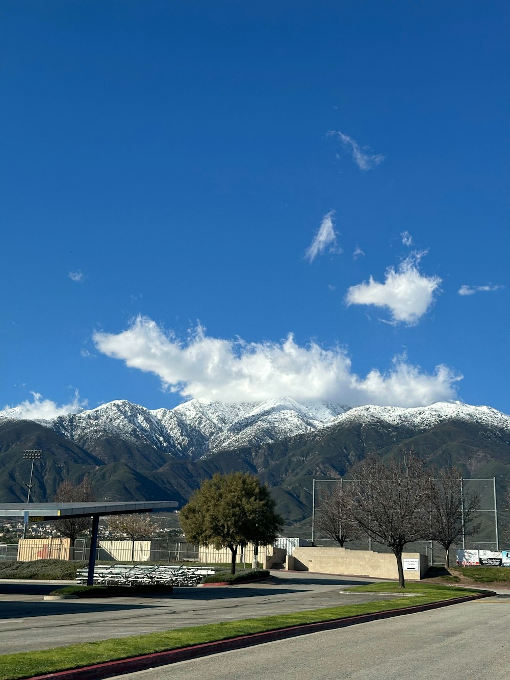 a view of a mountain range from a parking lot