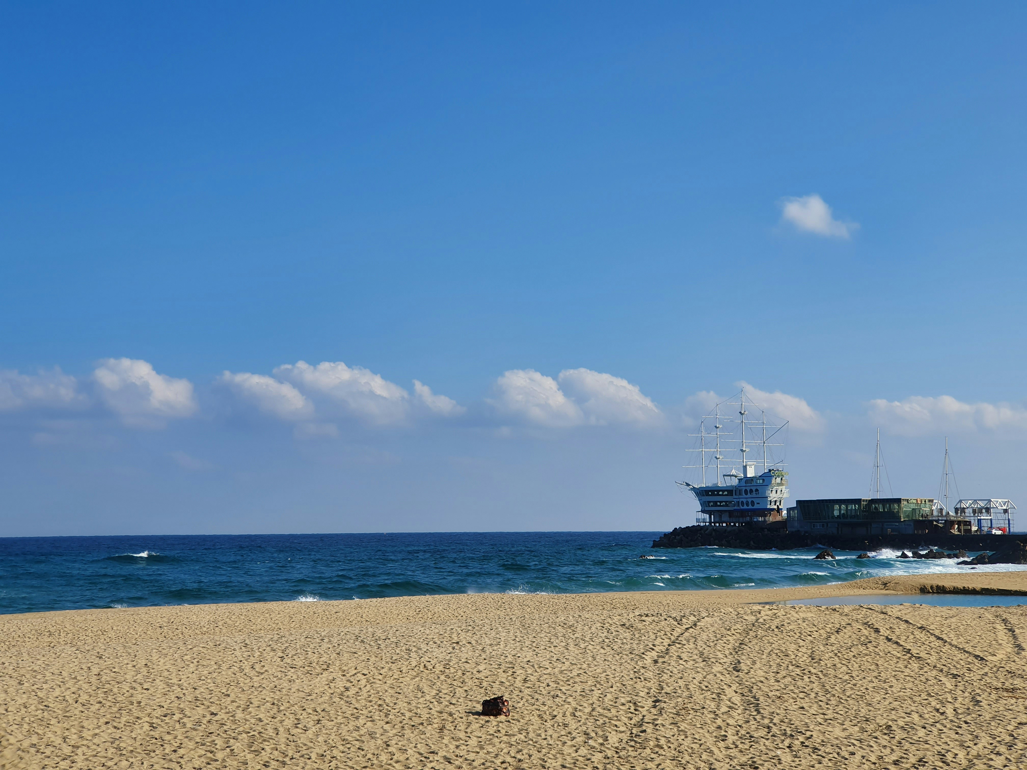 a boat is in the water near a beach