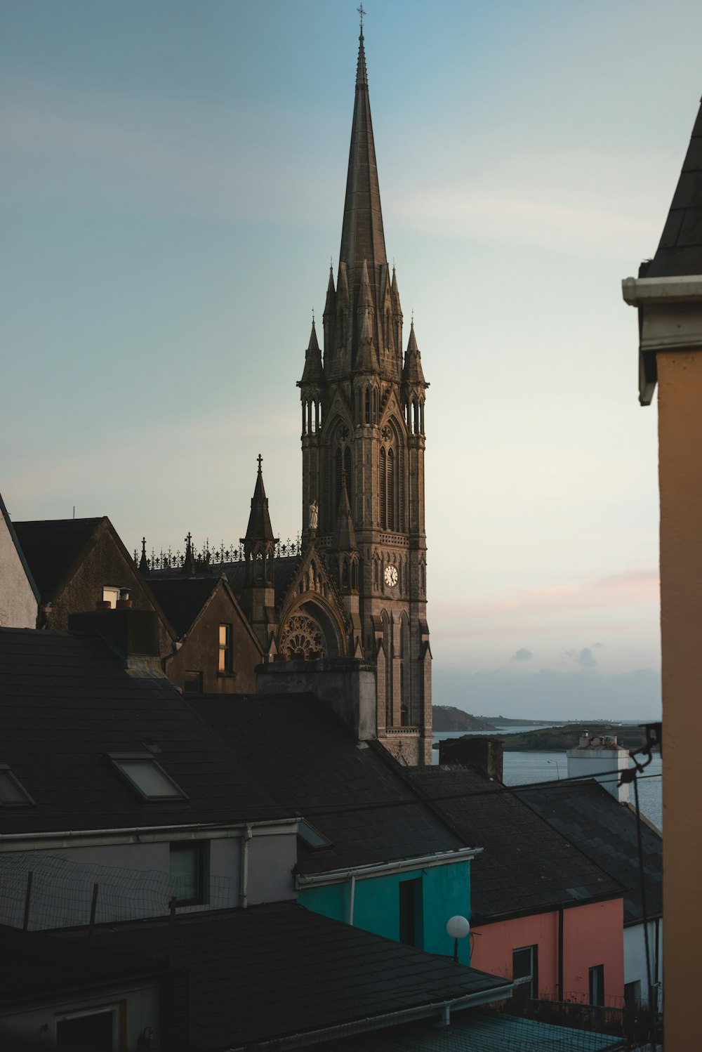 a view of a church with a clock tower in the background