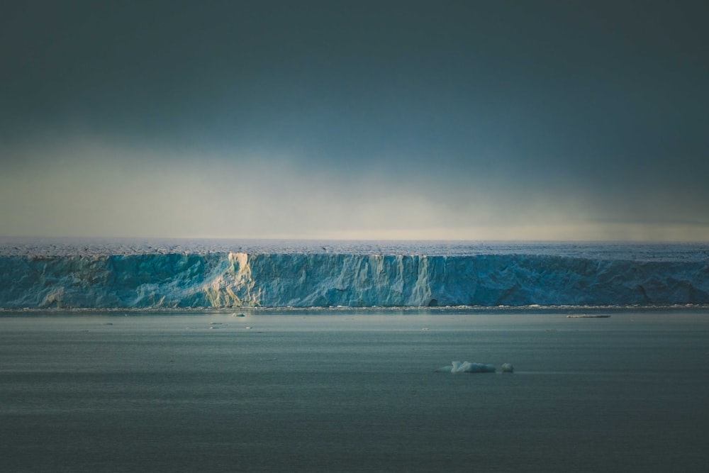 a large iceberg in the middle of the ocean