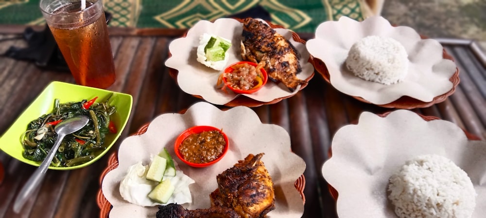 a table topped with plates of food and drinks