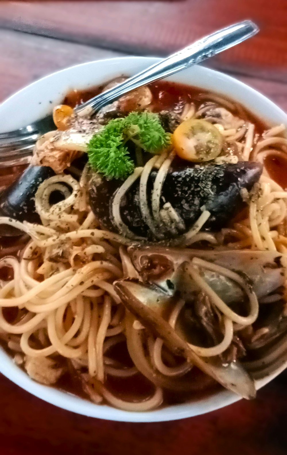 a bowl of noodles with meat and vegetables