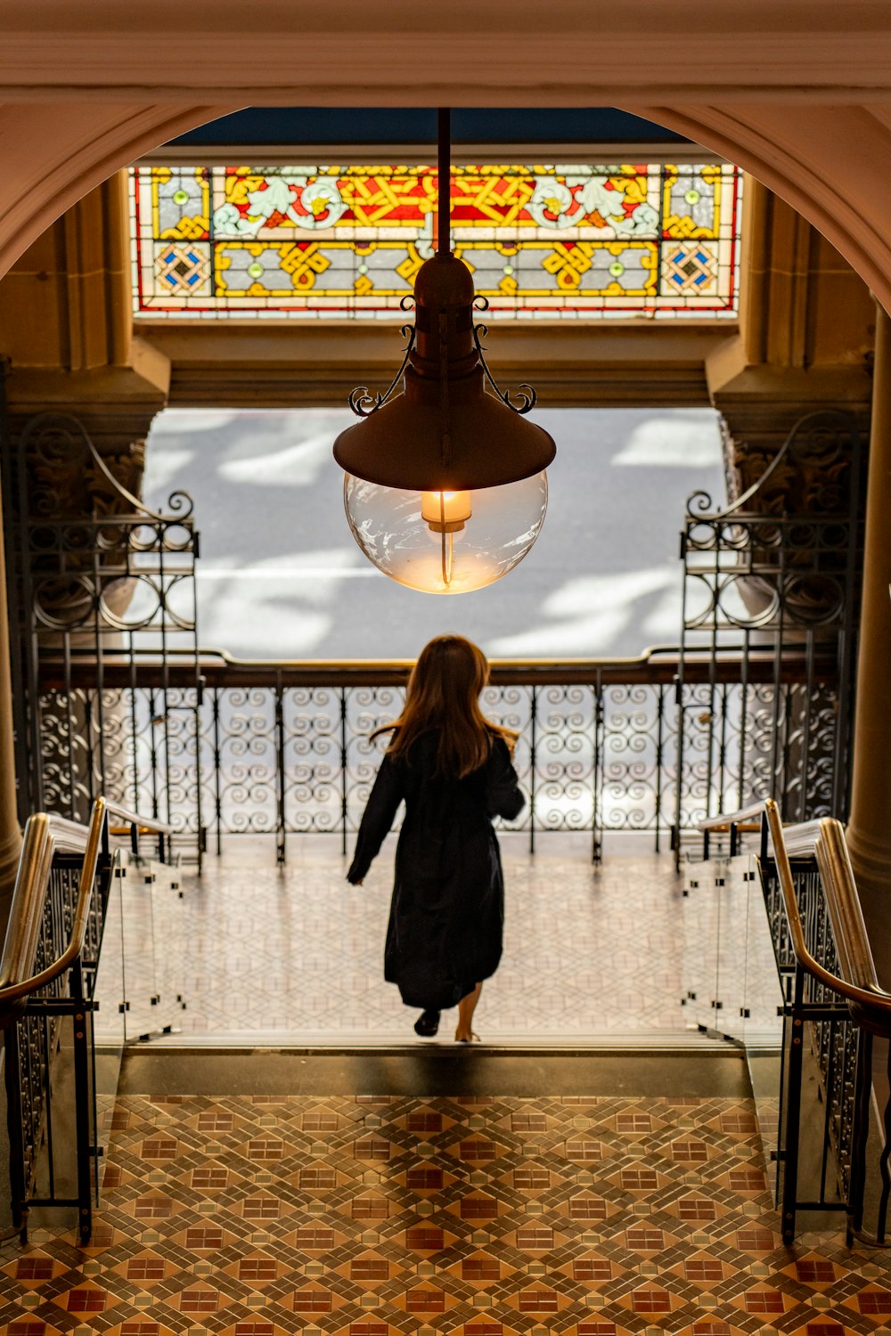 a woman is walking down a hall way
