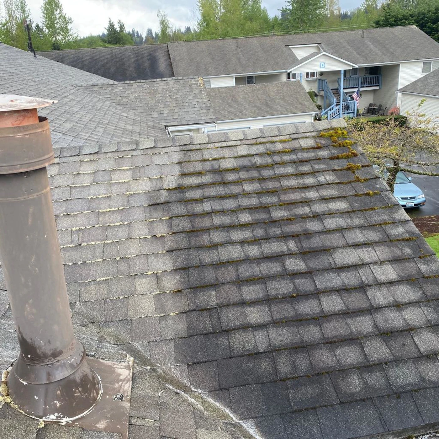 Worker cleaning a residential roof