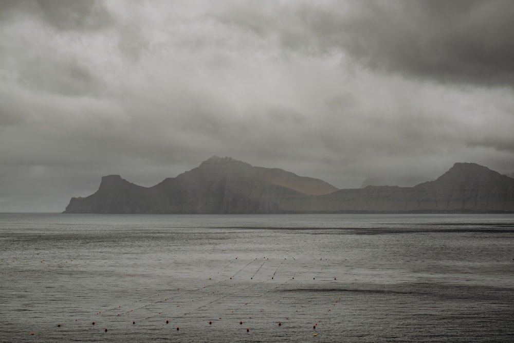 a large body of water with mountains in the background