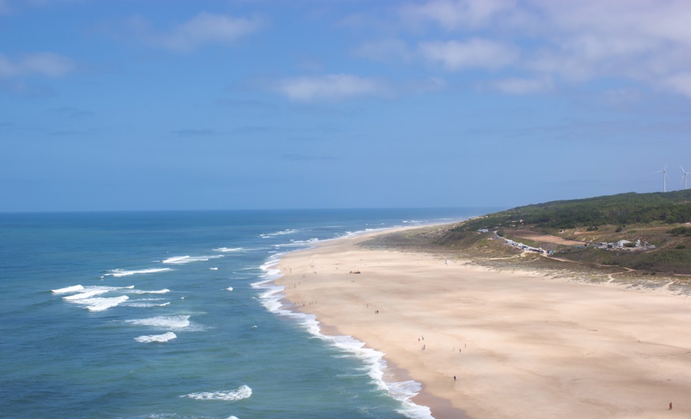 a view of a beach from the top of a hill