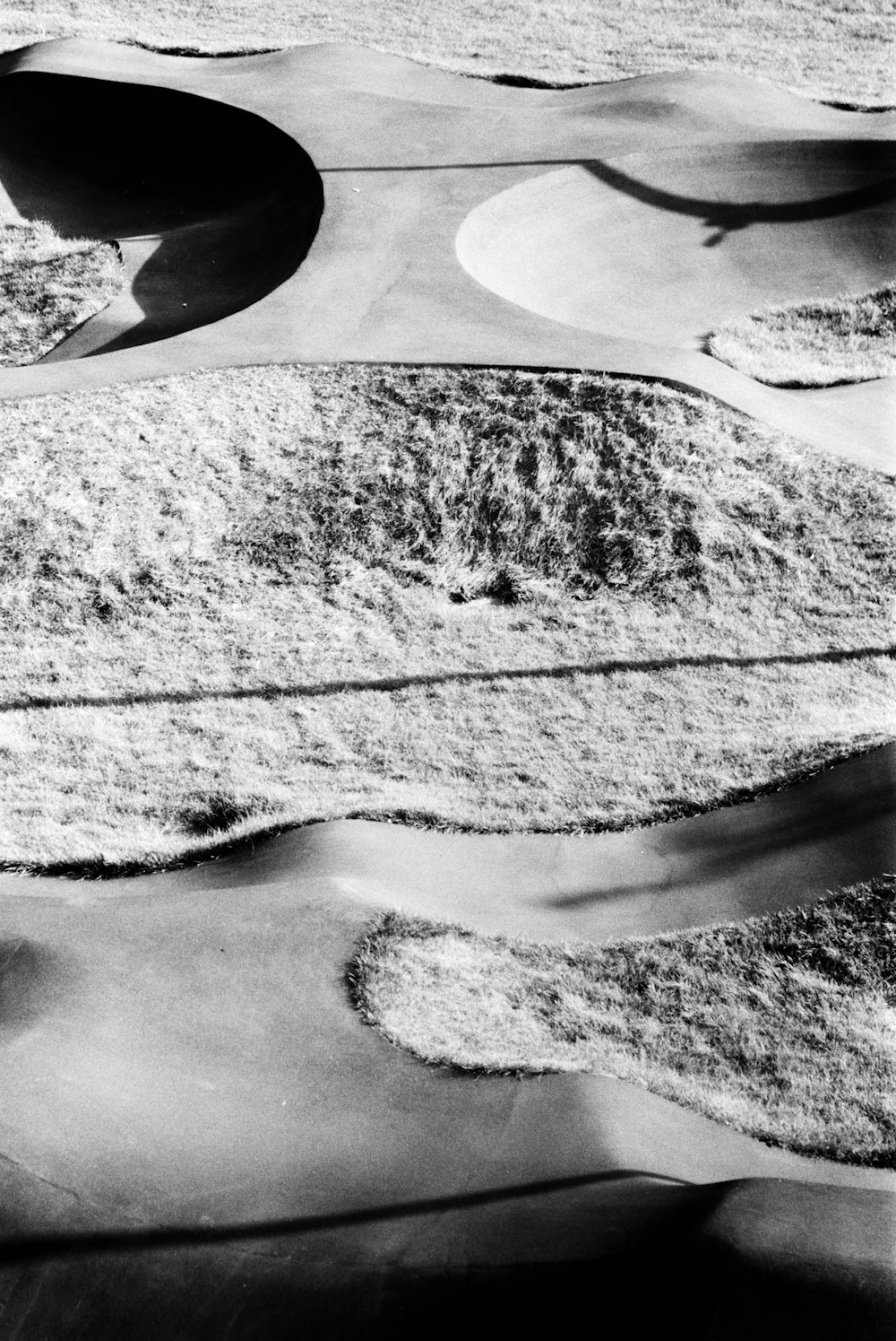 a black and white photo of sand dunes
