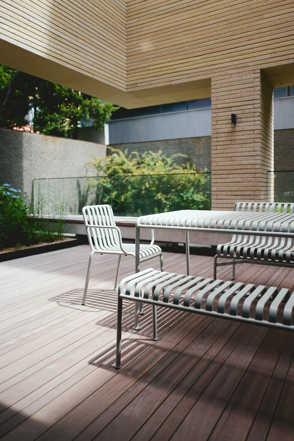 a couple of chairs sitting on top of a wooden deck