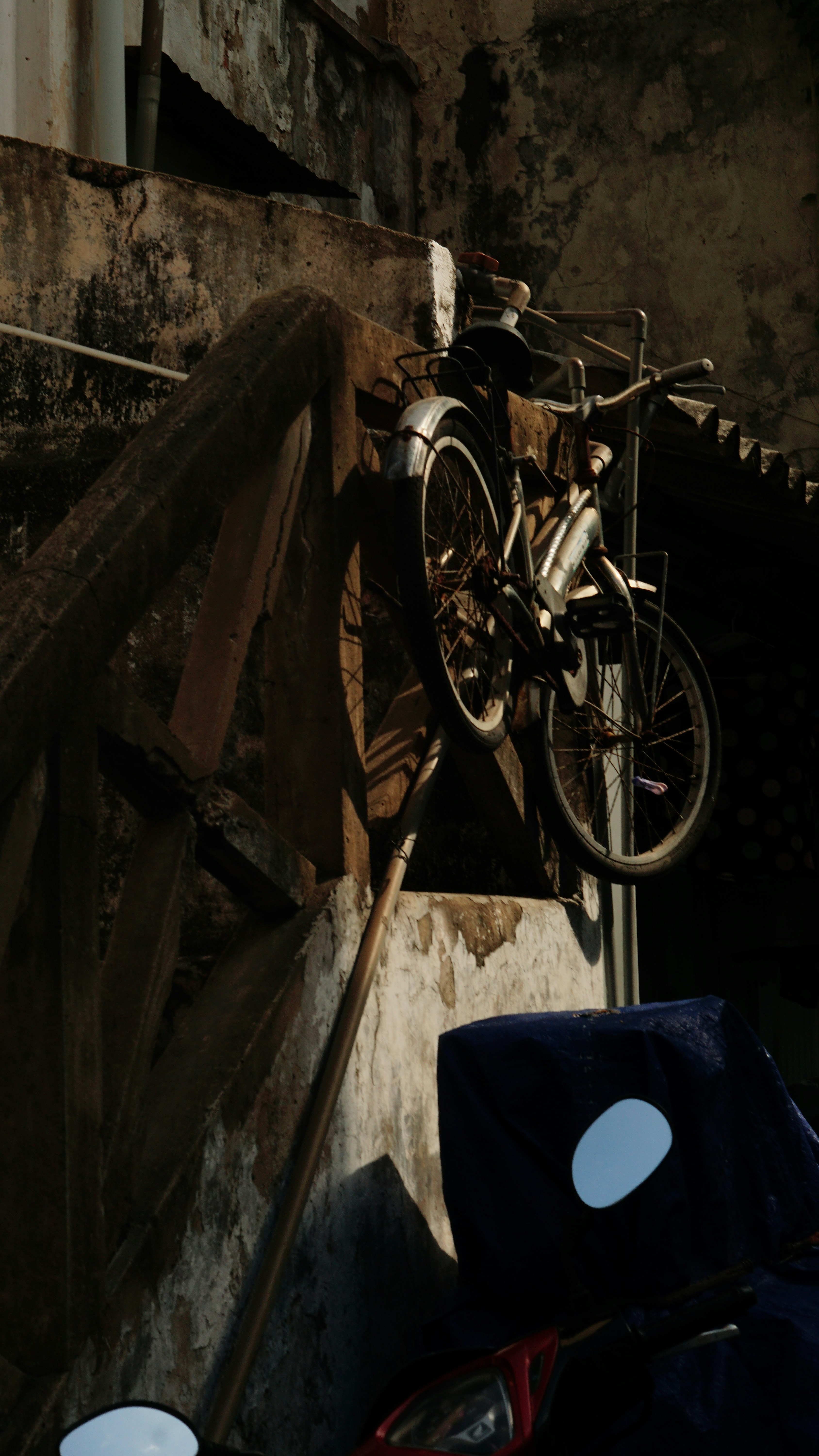 a bike hanging on the side of a building