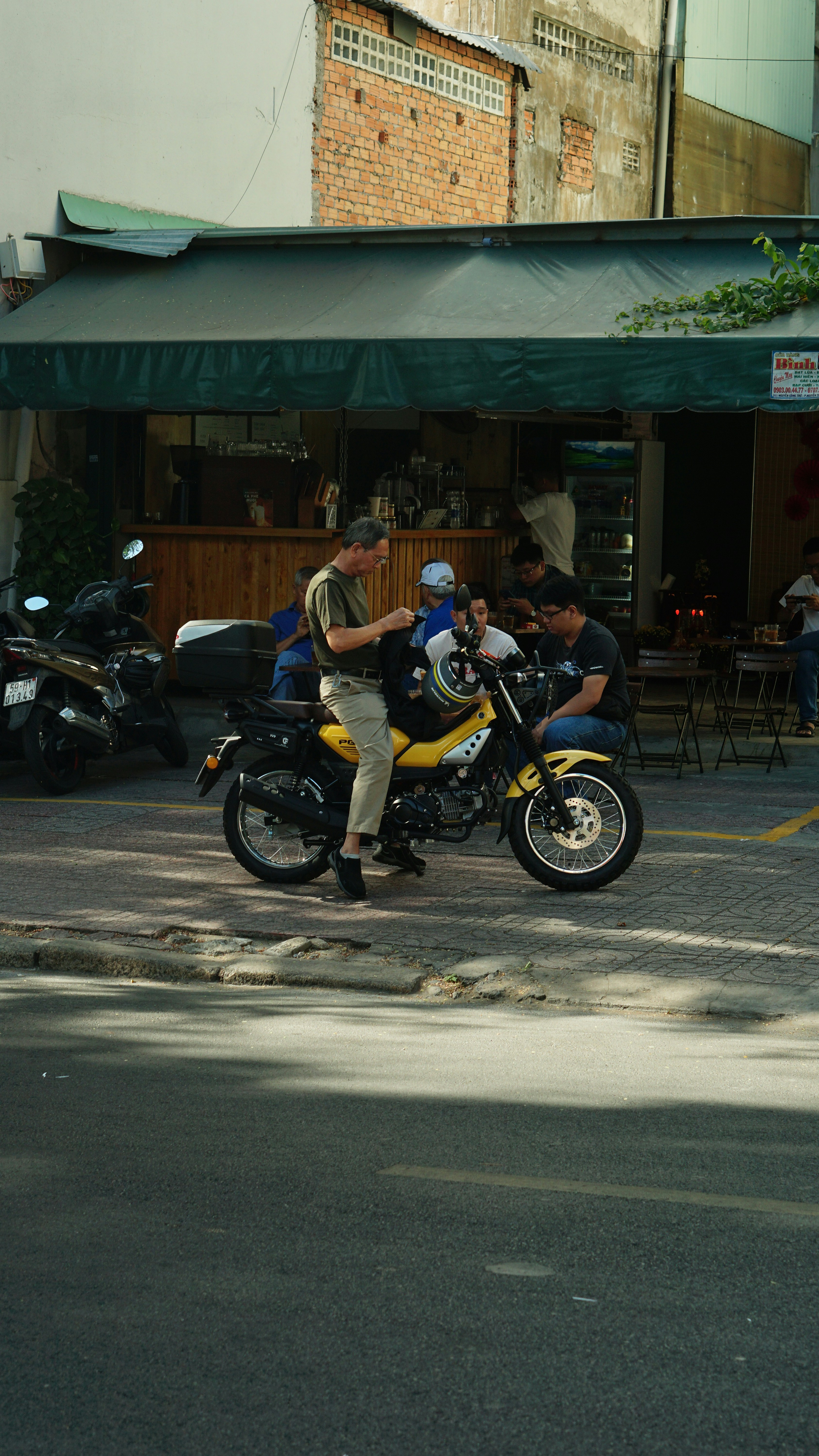 a man riding a motorcycle down a street