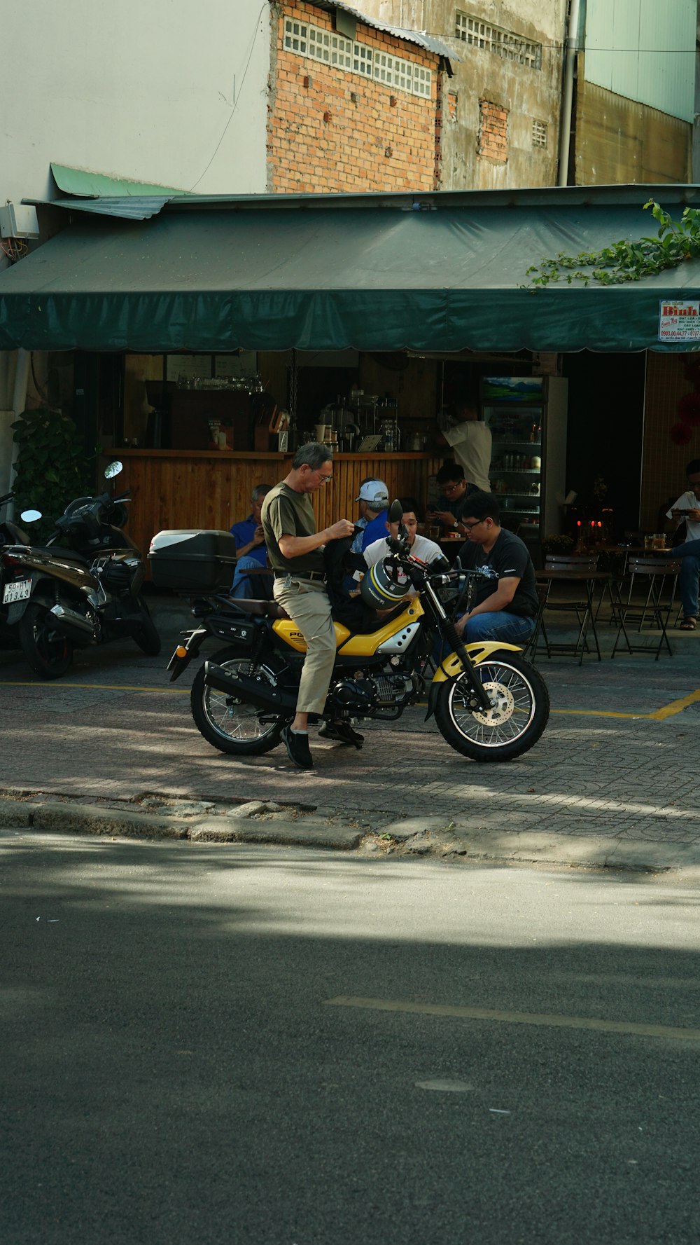 a man riding a motorcycle down a street