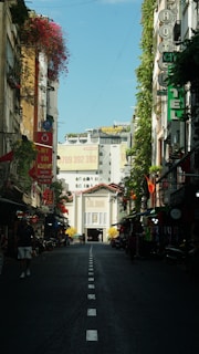 a narrow street with buildings and signs on both sides