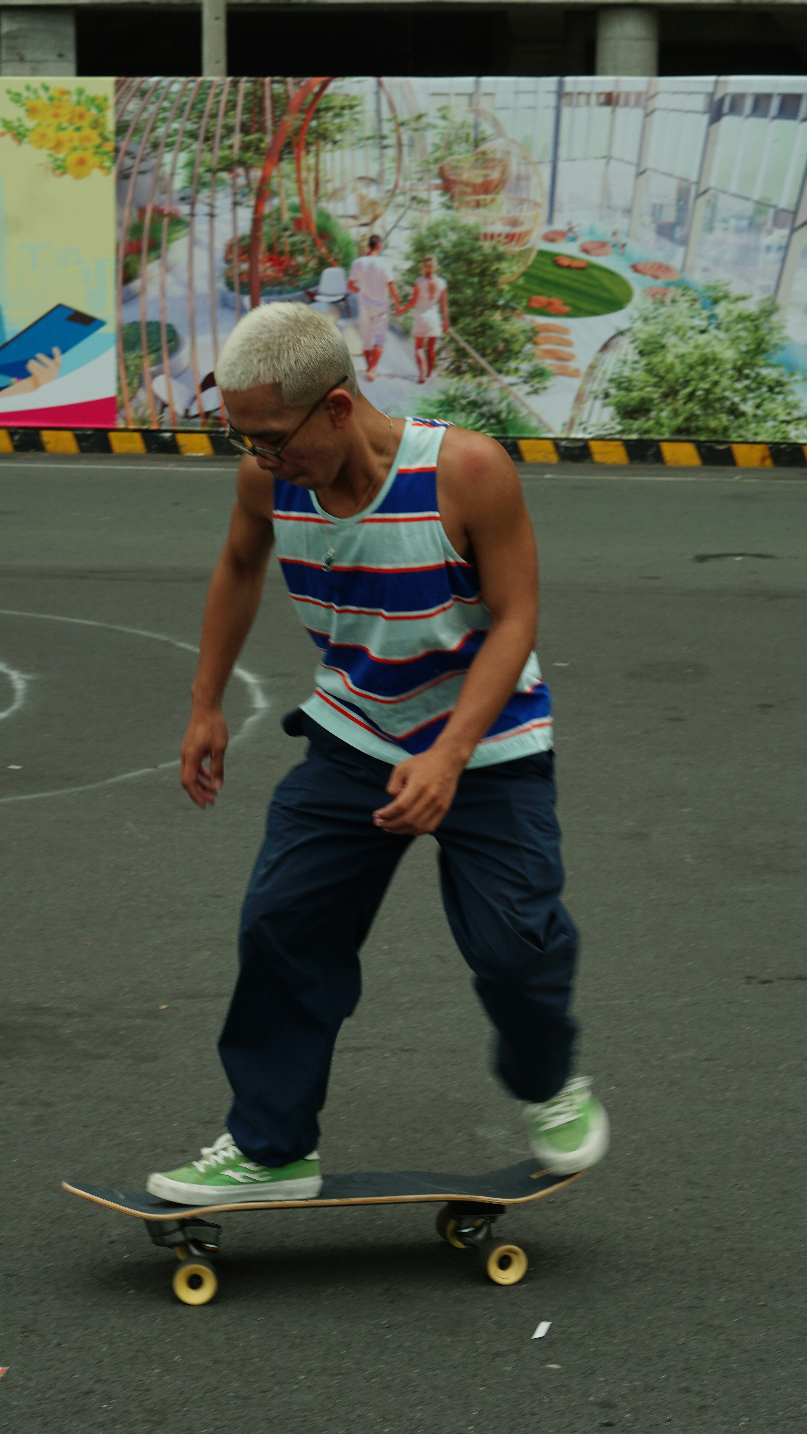 a man riding a skateboard down a street