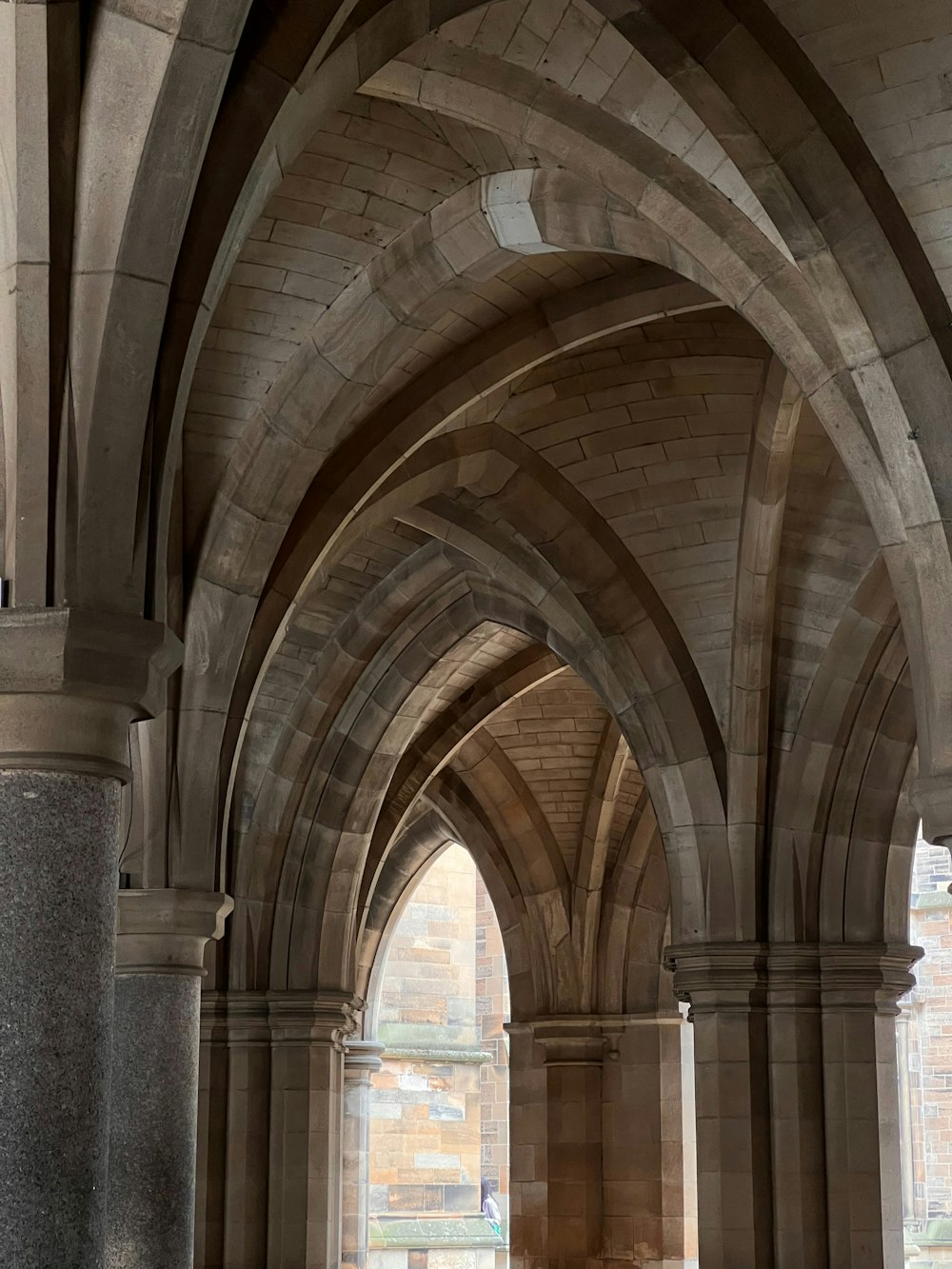 a large stone building with arches and a clock