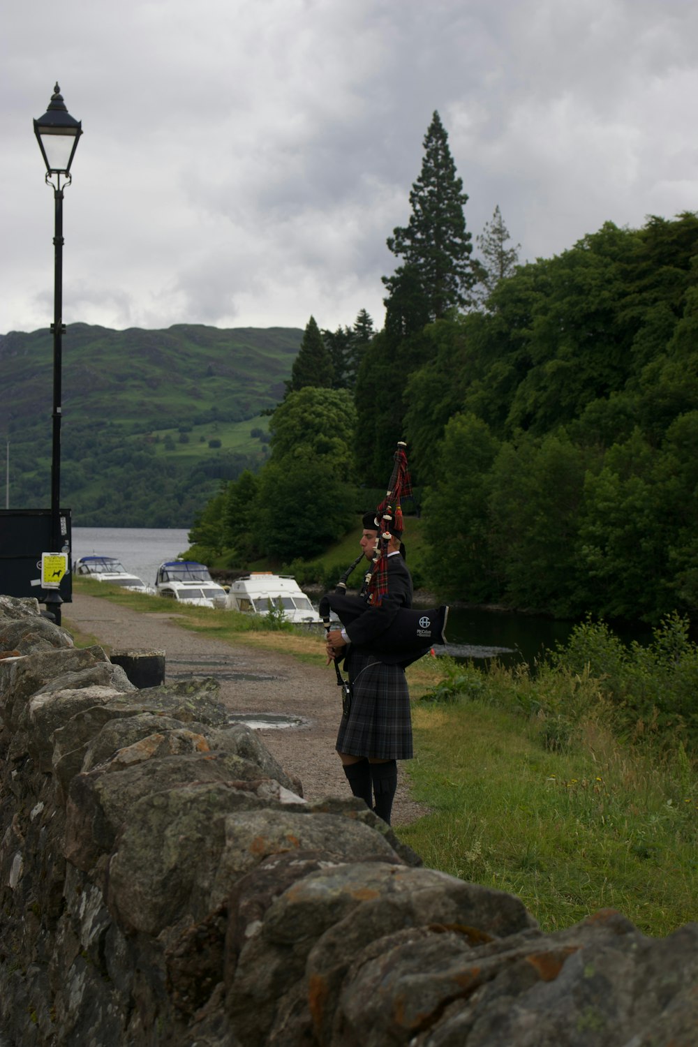 a man in a kilt playing a bagpipe