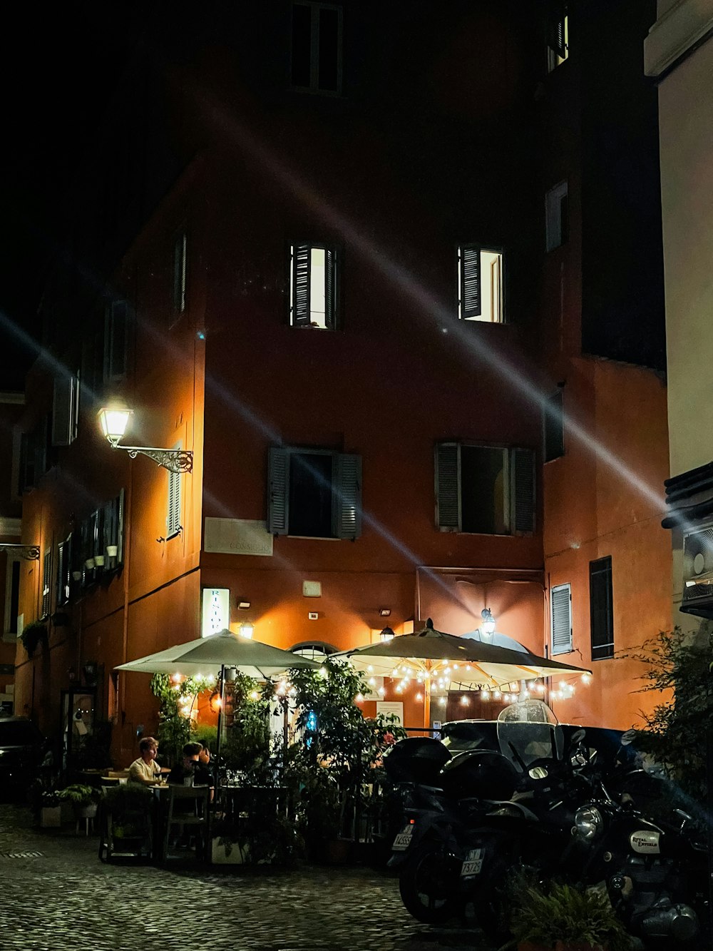 a motorcycle parked in front of a building at night