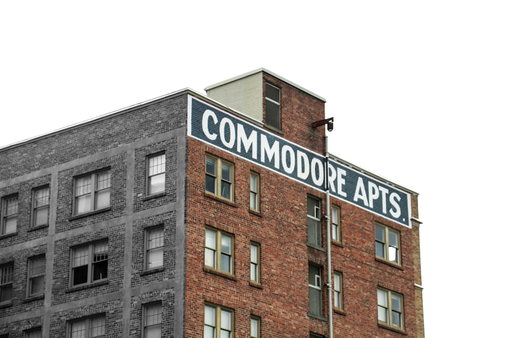 a tall brick building with a sign on top of it