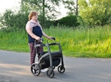 a woman pushing a walker down the street