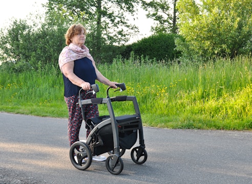 a woman pushing a walker down the street