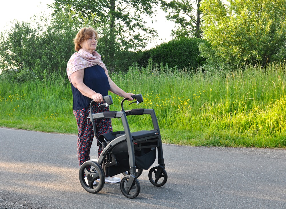 a woman pushing a walker down the street