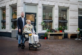 a man and a woman walking with a baby in a stroller
