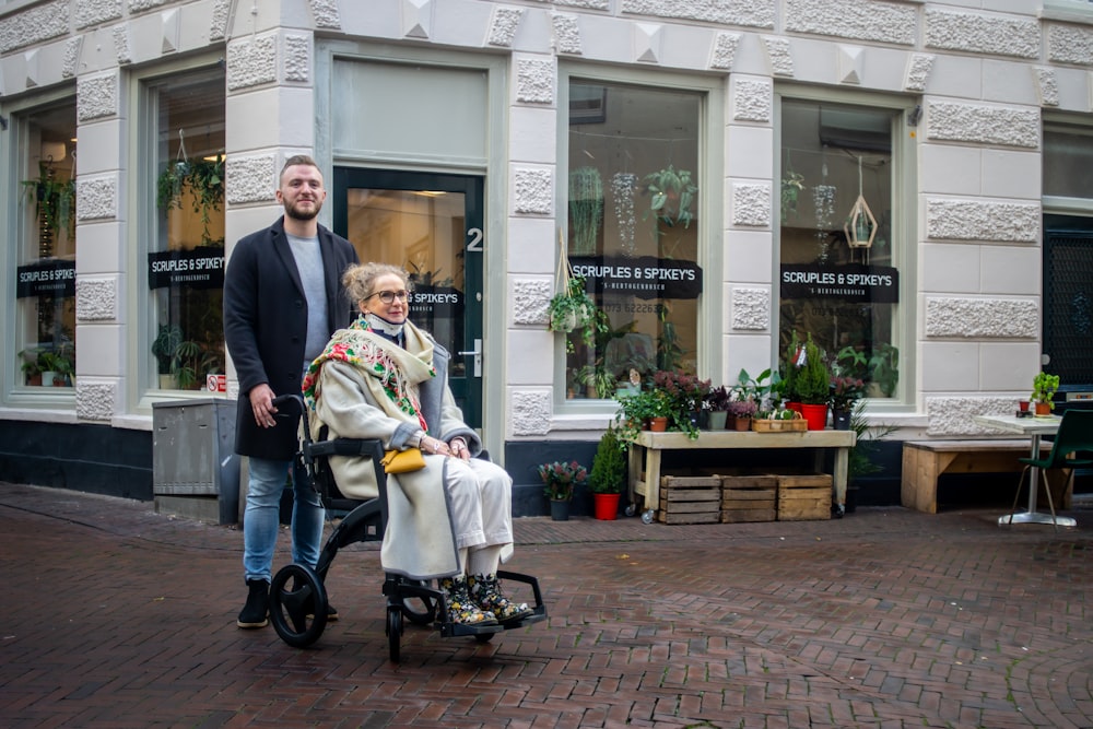 a man and a woman walking with a baby in a stroller