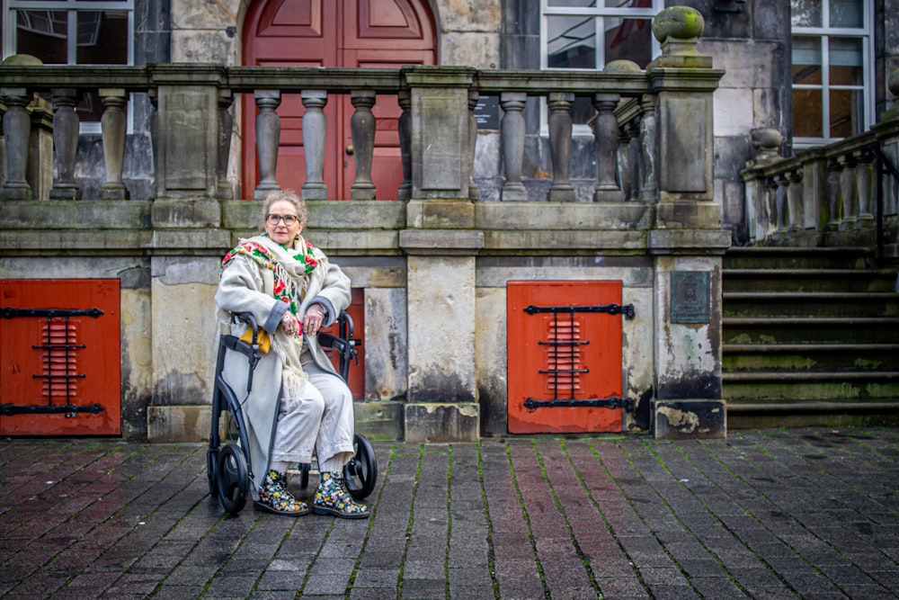 a woman sitting on a scooter in front of a building