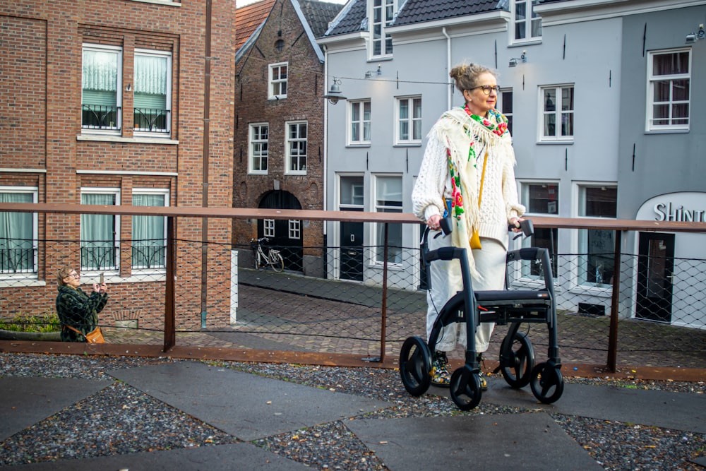 a woman standing on a balcony with a walker