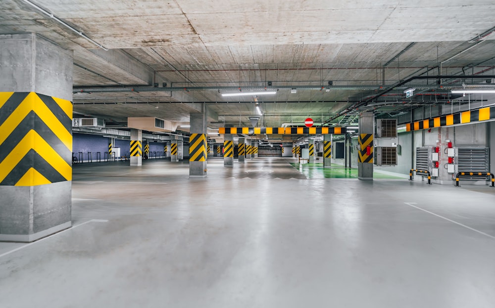 an empty parking garage with yellow and black stripes