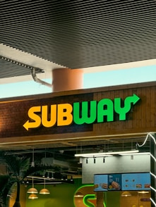 a subway sign above a subway entrance