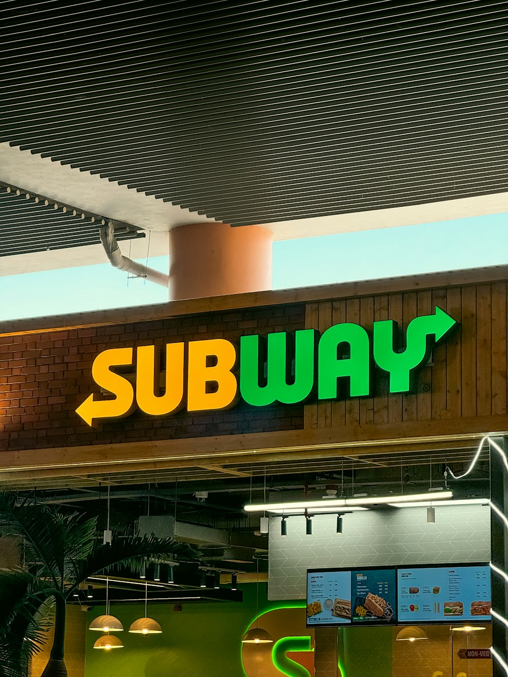 a subway sign above a subway entrance