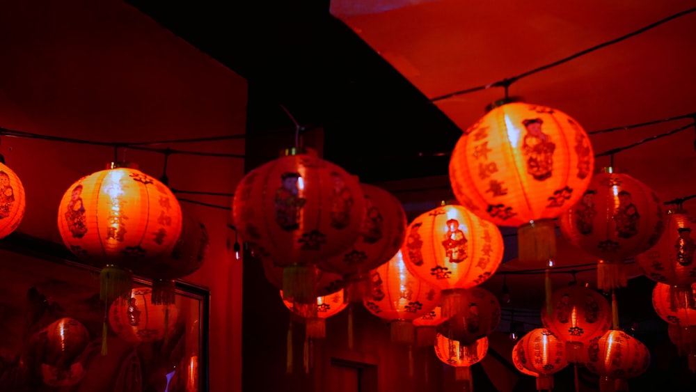 a group of red lanterns hanging from a ceiling