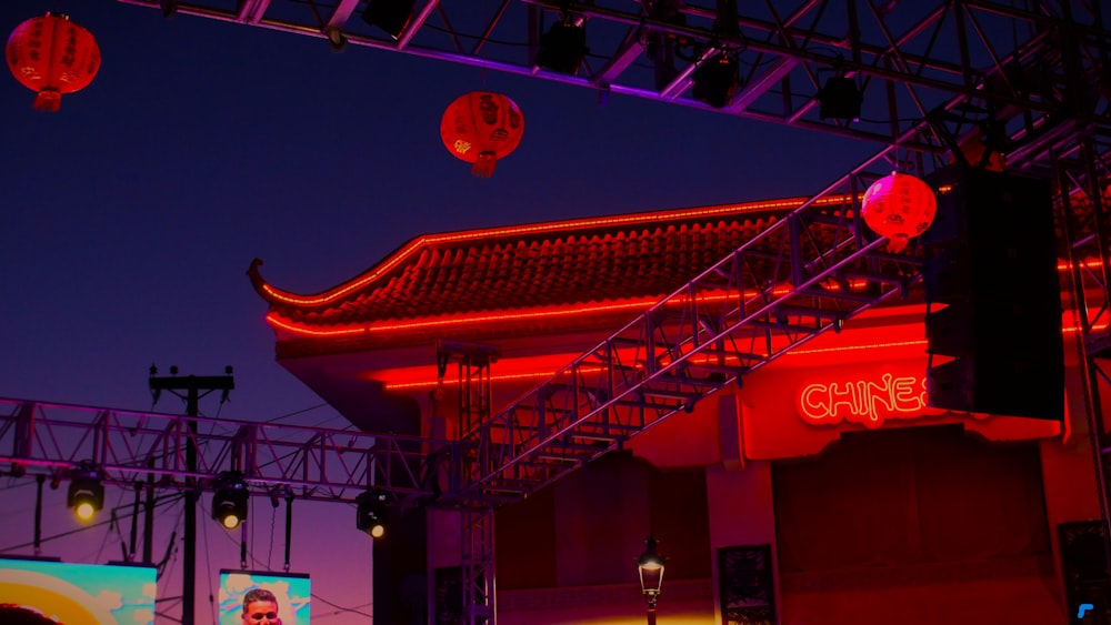 a stage set up with red lights and lanterns