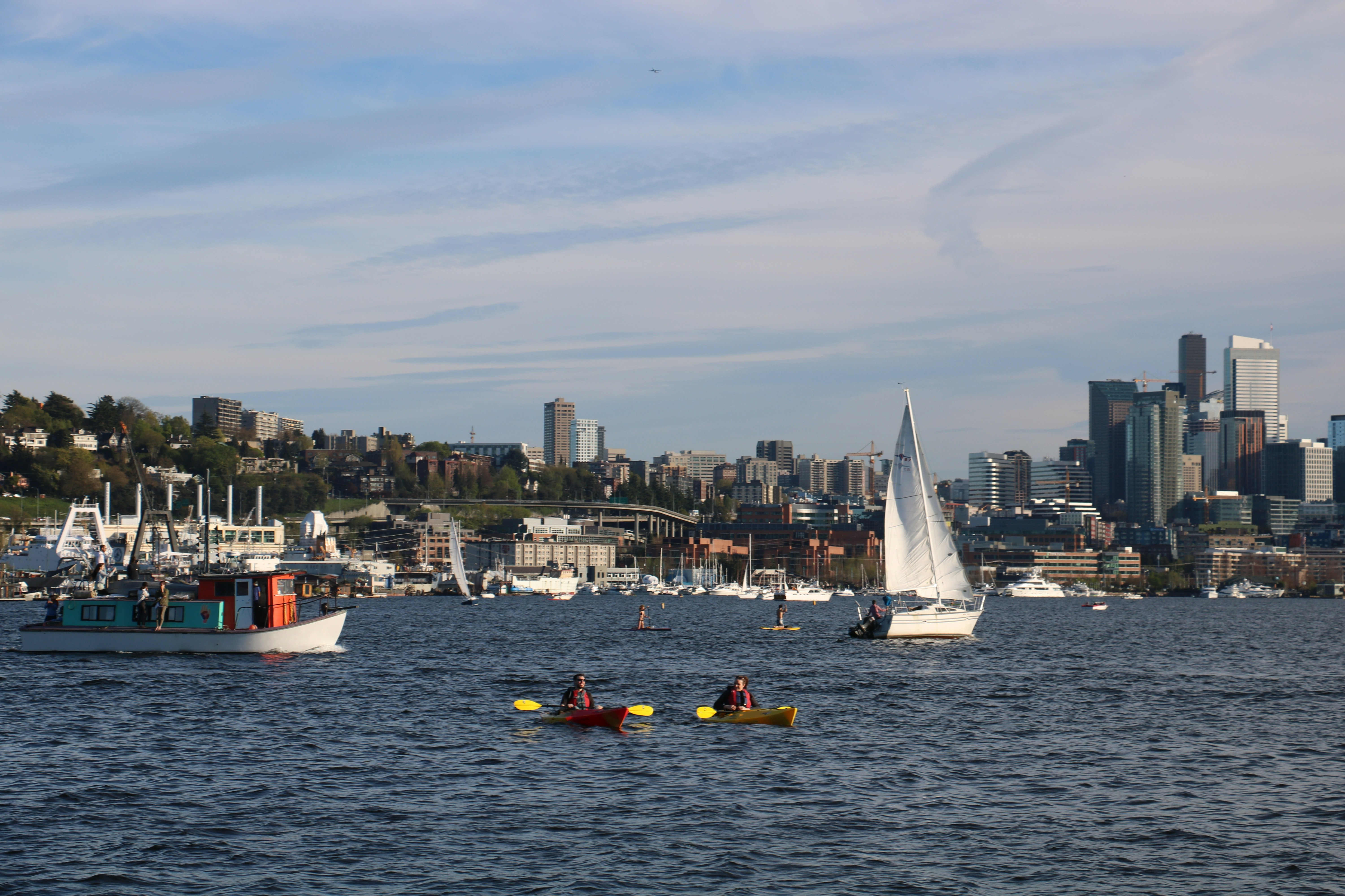 People love doing water activities with sailboats and kayaks on Lake Union in Seattle in the summer.