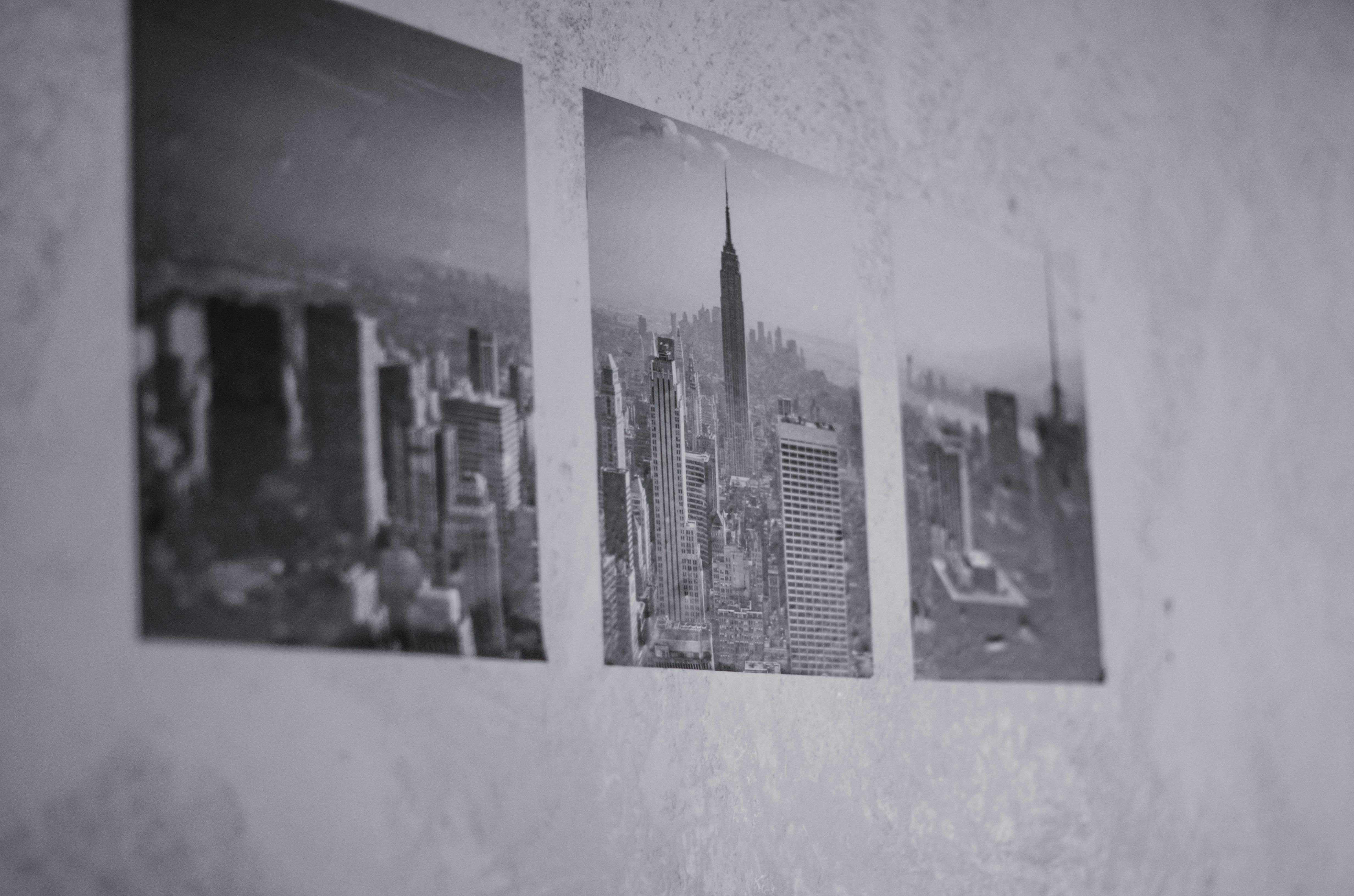 a wall with three pictures hanging on it