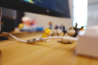 a group of small toy animals sitting on top of a wooden table