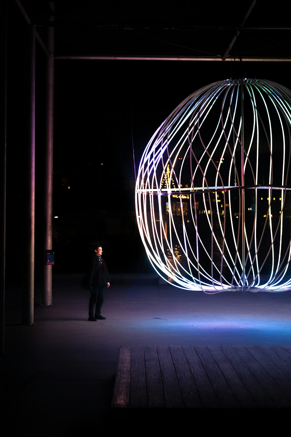 a man standing in front of a large light ball