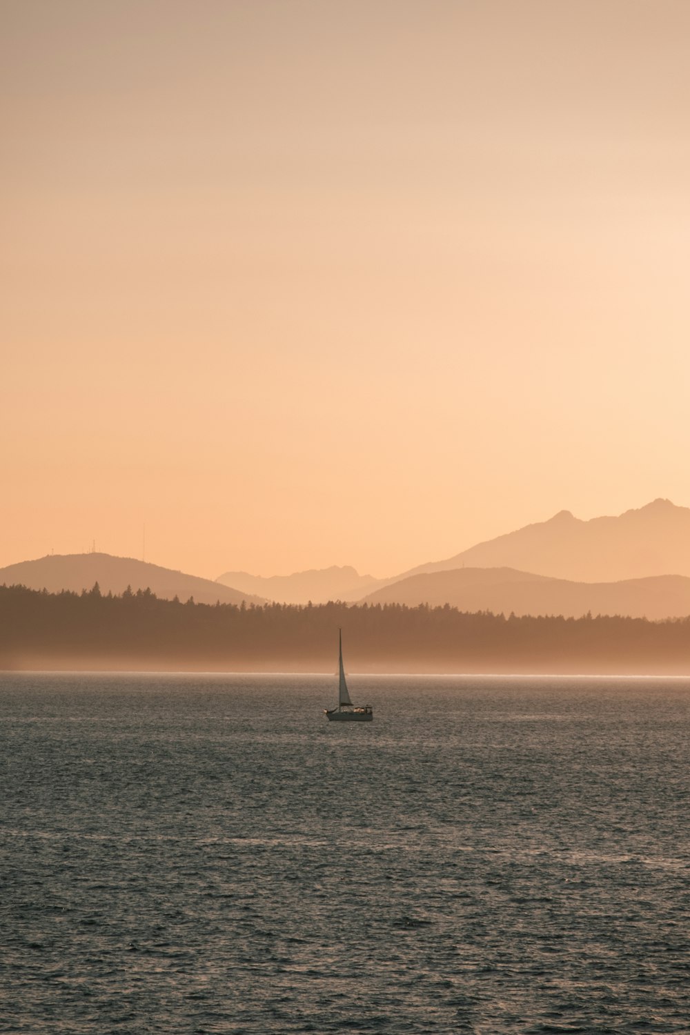 a sailboat in the middle of a body of water