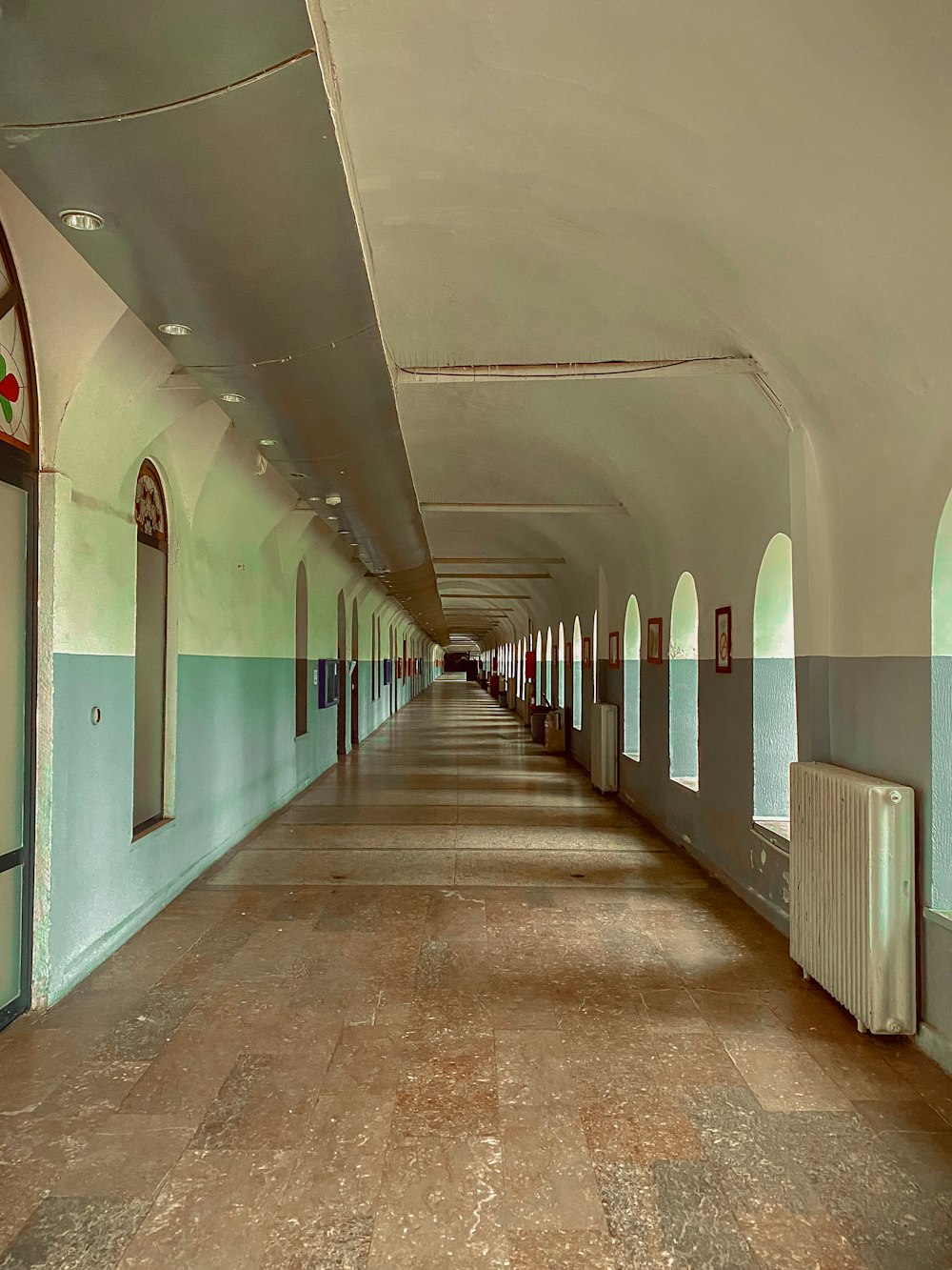 a long hallway with a clock on the wall