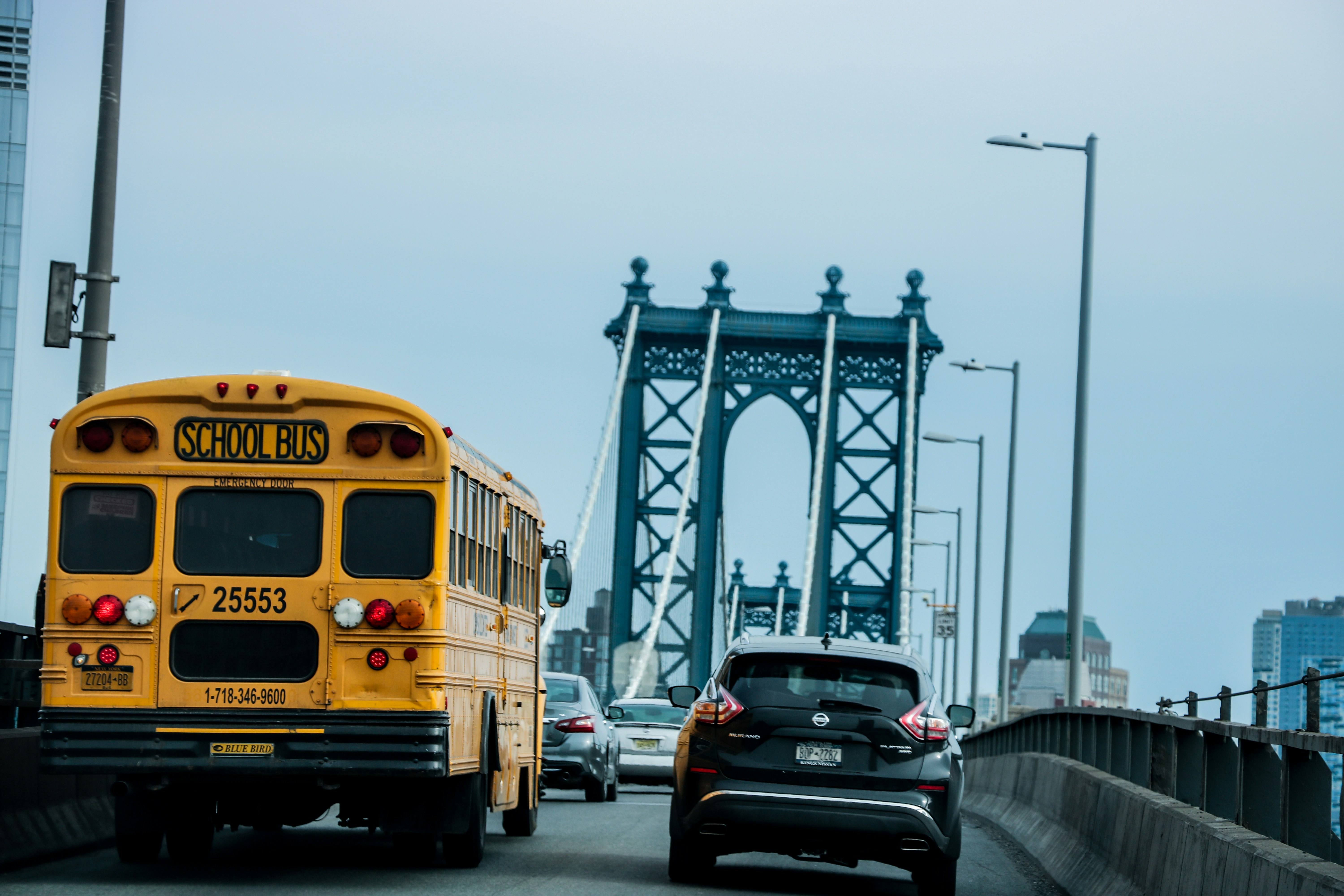 A yellow school bus on Brooklyn Bridge New York City