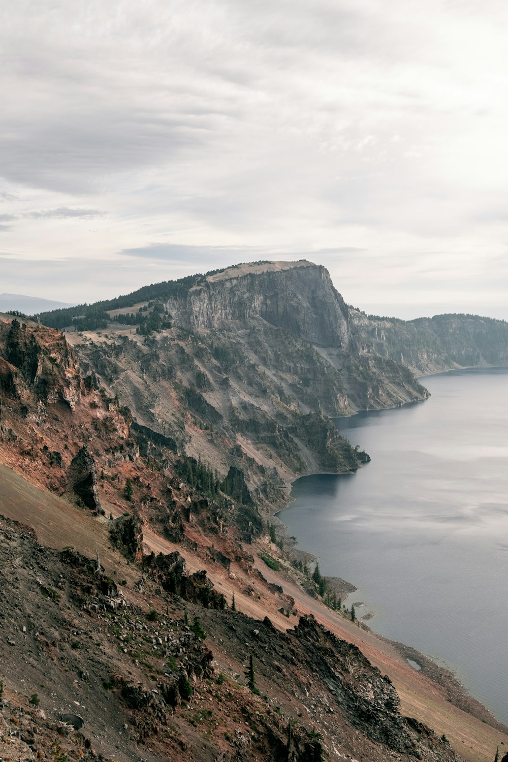 a large body of water sitting on the side of a mountain