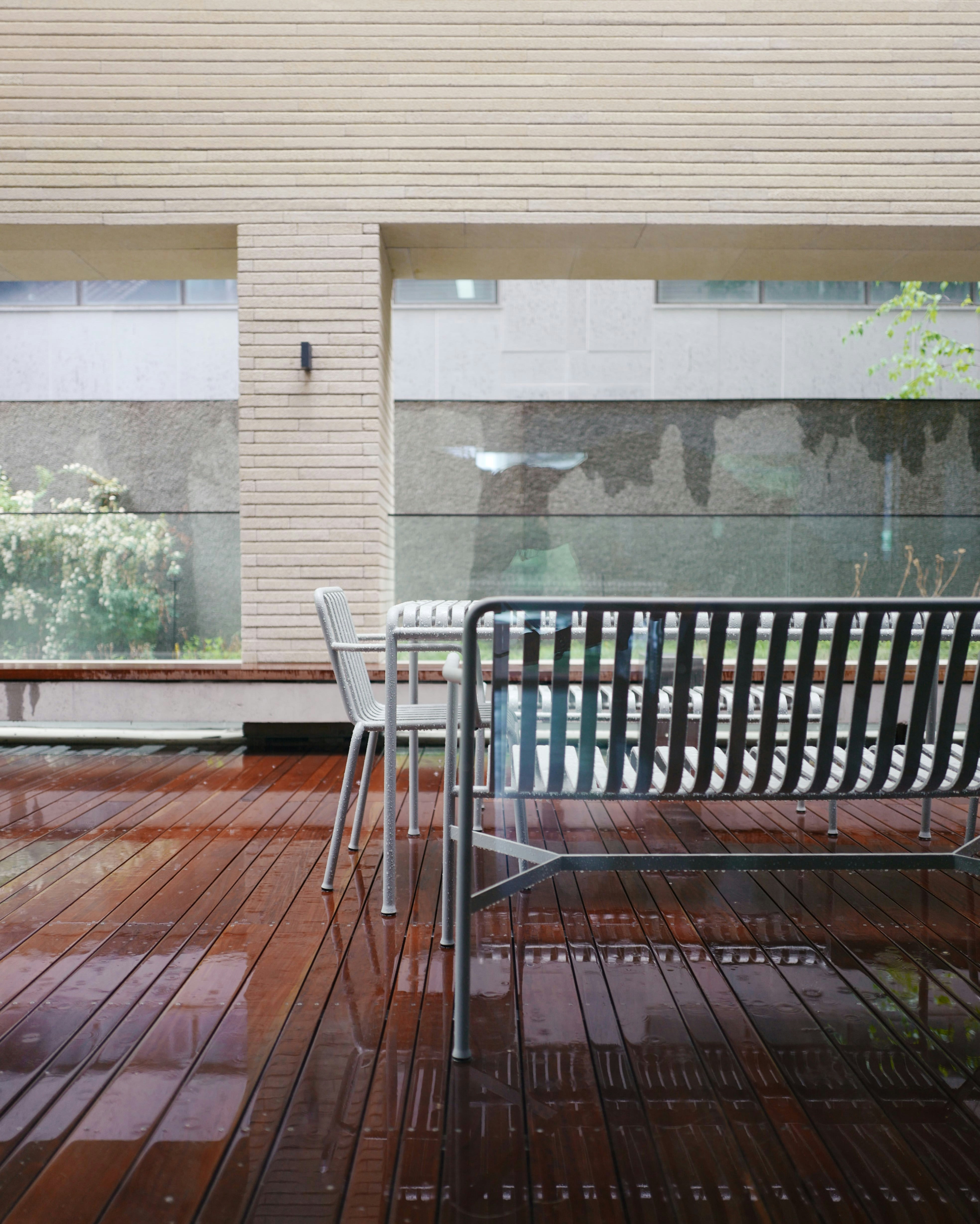 a metal bench sitting on top of a wooden floor