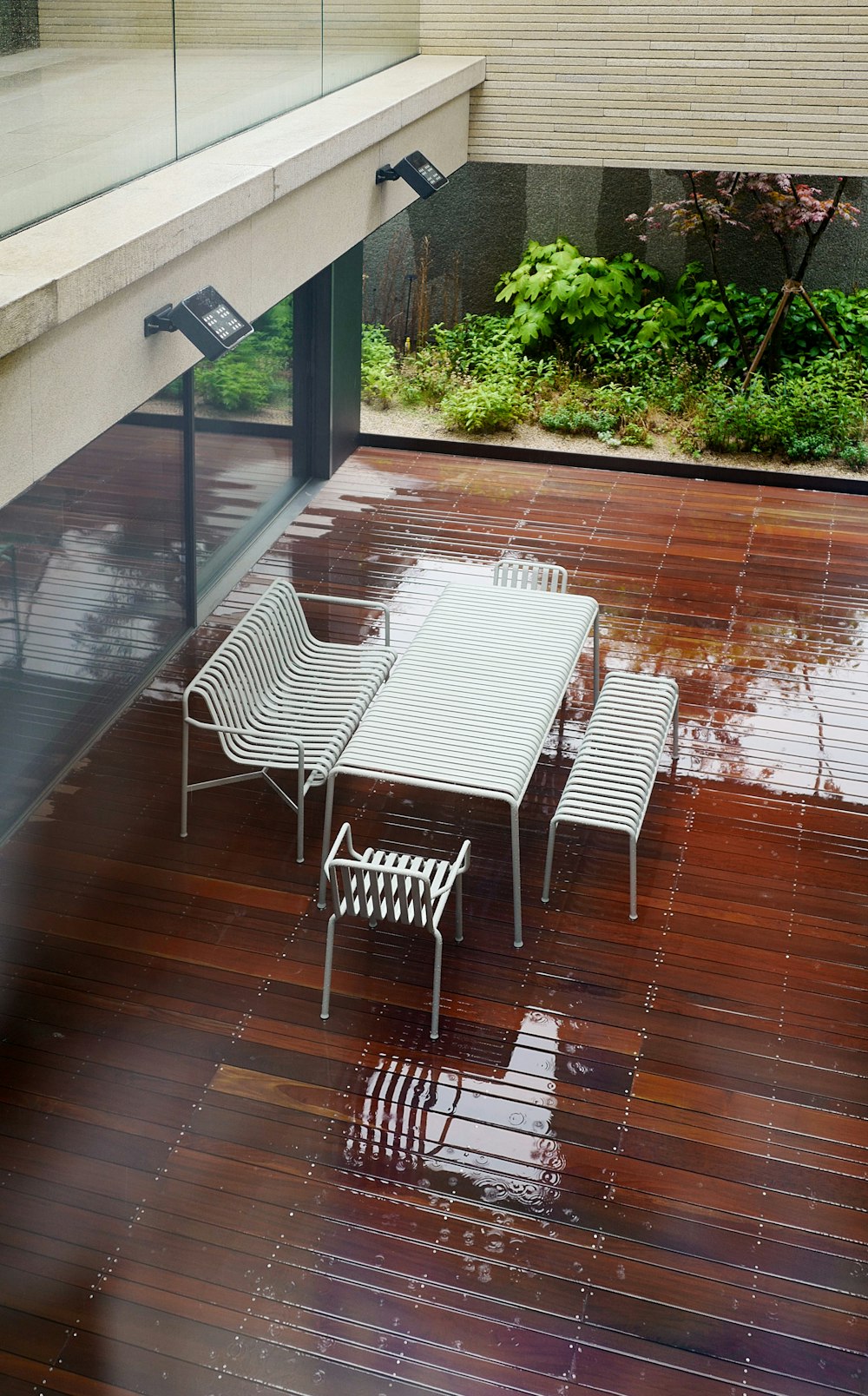 a white table and chairs on a wooden floor