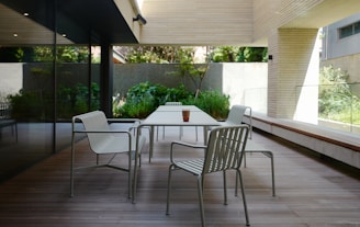 a table and chairs on a wooden deck